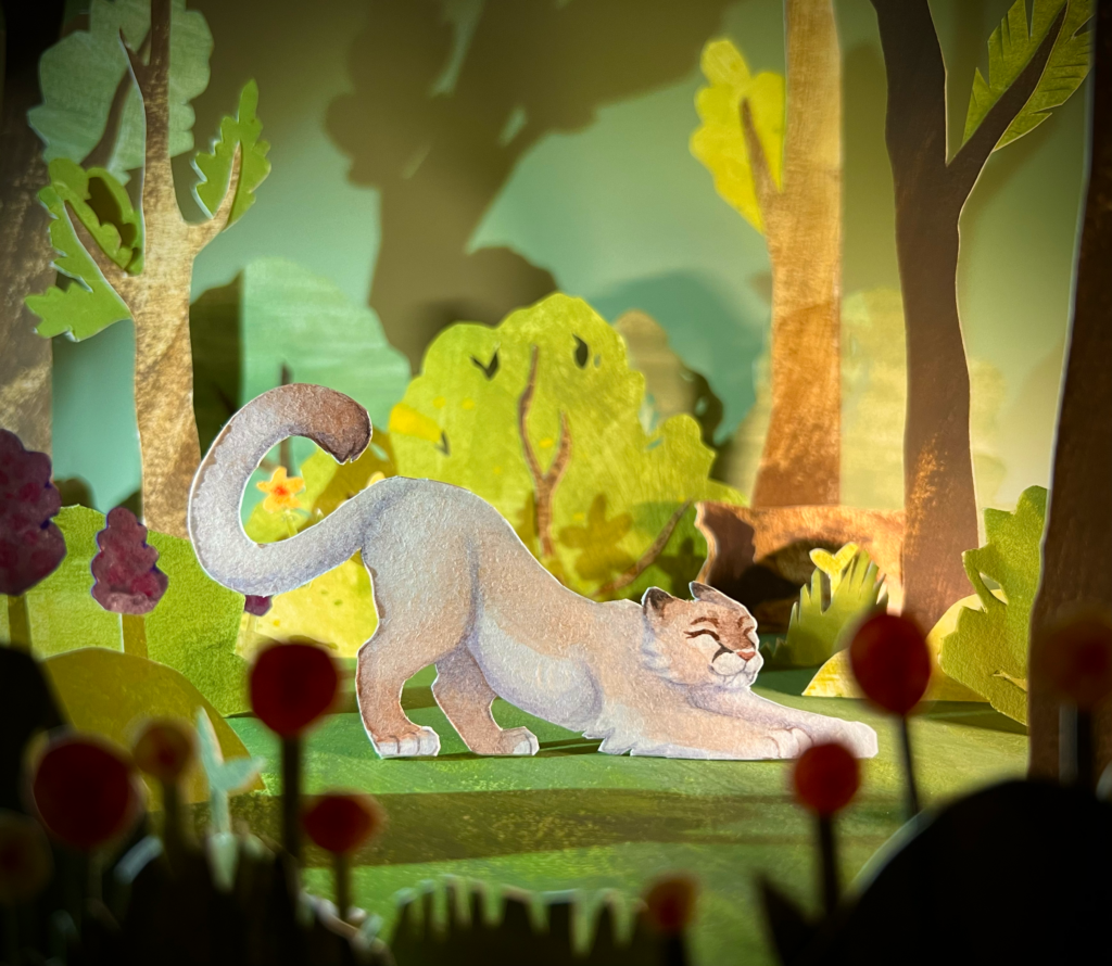 Paper craft diorama of puma in the forest