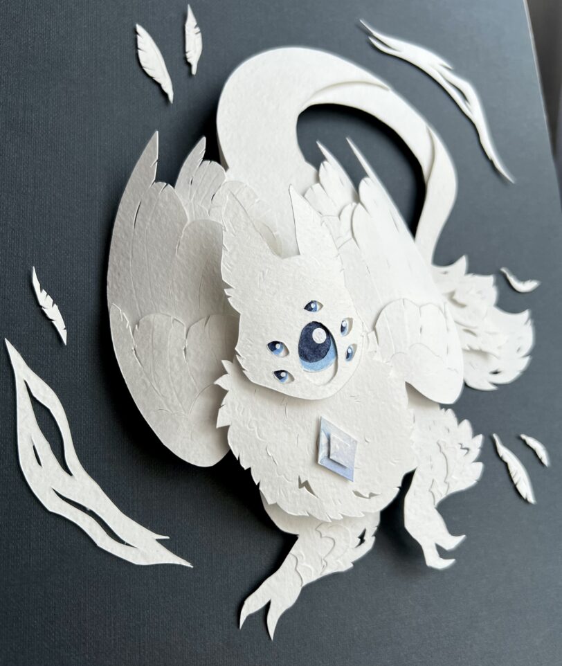 Paper craft of a white creature with wings