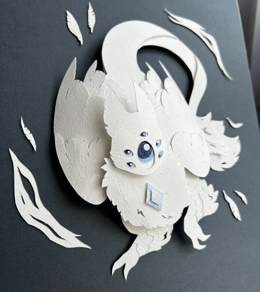 Paper craft of a white creature with wings