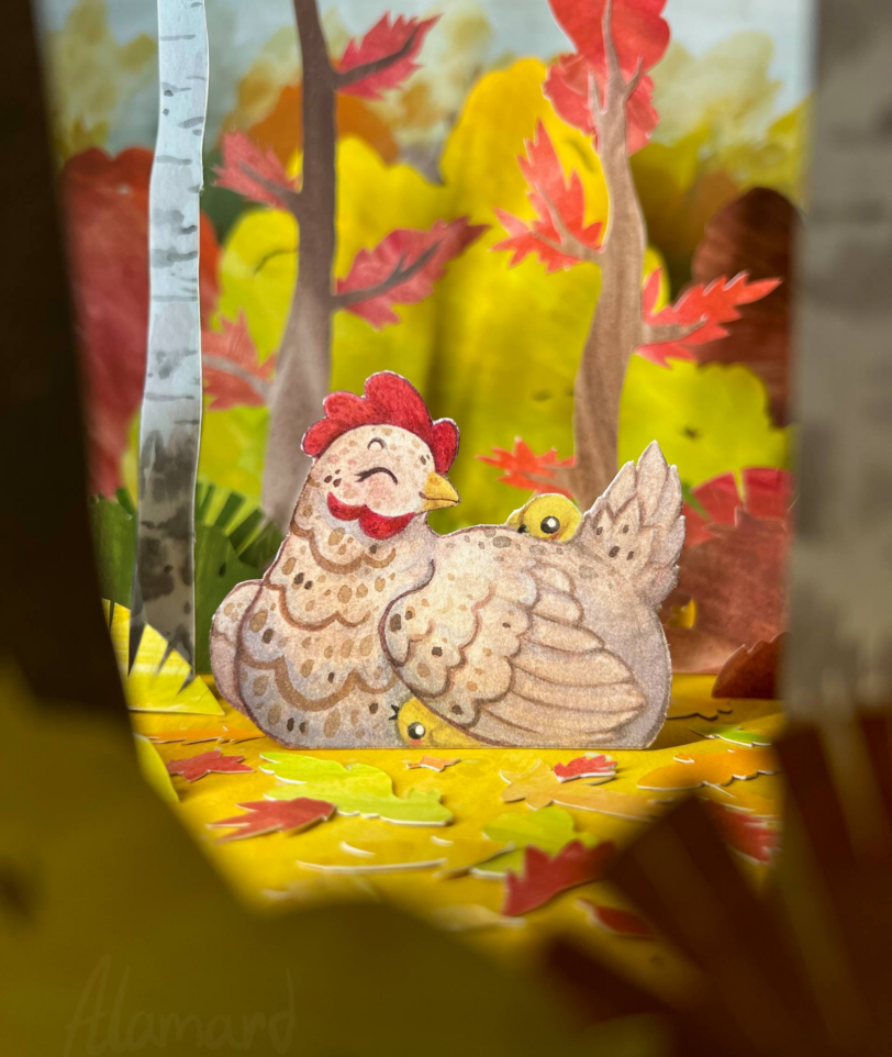 Paper craft diorama of a chicken with her chicks in an autumn forest